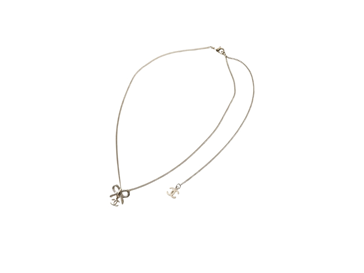 https://d2cva83hdk3bwc.cloudfront.net/abg556-b21218-u2248-chanel-bow-and-dangling-logo-necklace-2.jpg