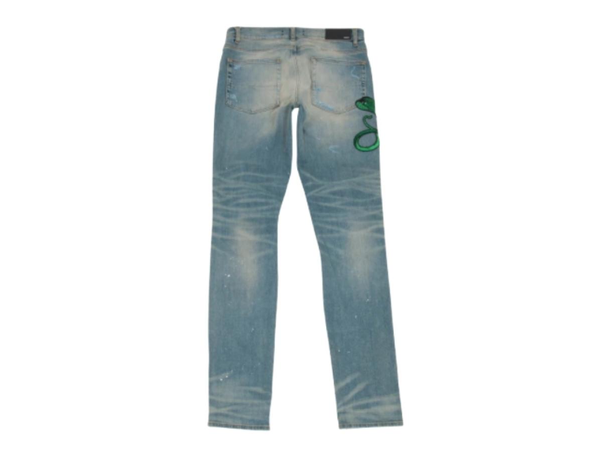 https://d2cva83hdk3bwc.cloudfront.net/amiri-indigo-snake-art-patch-jeans-2.jpg