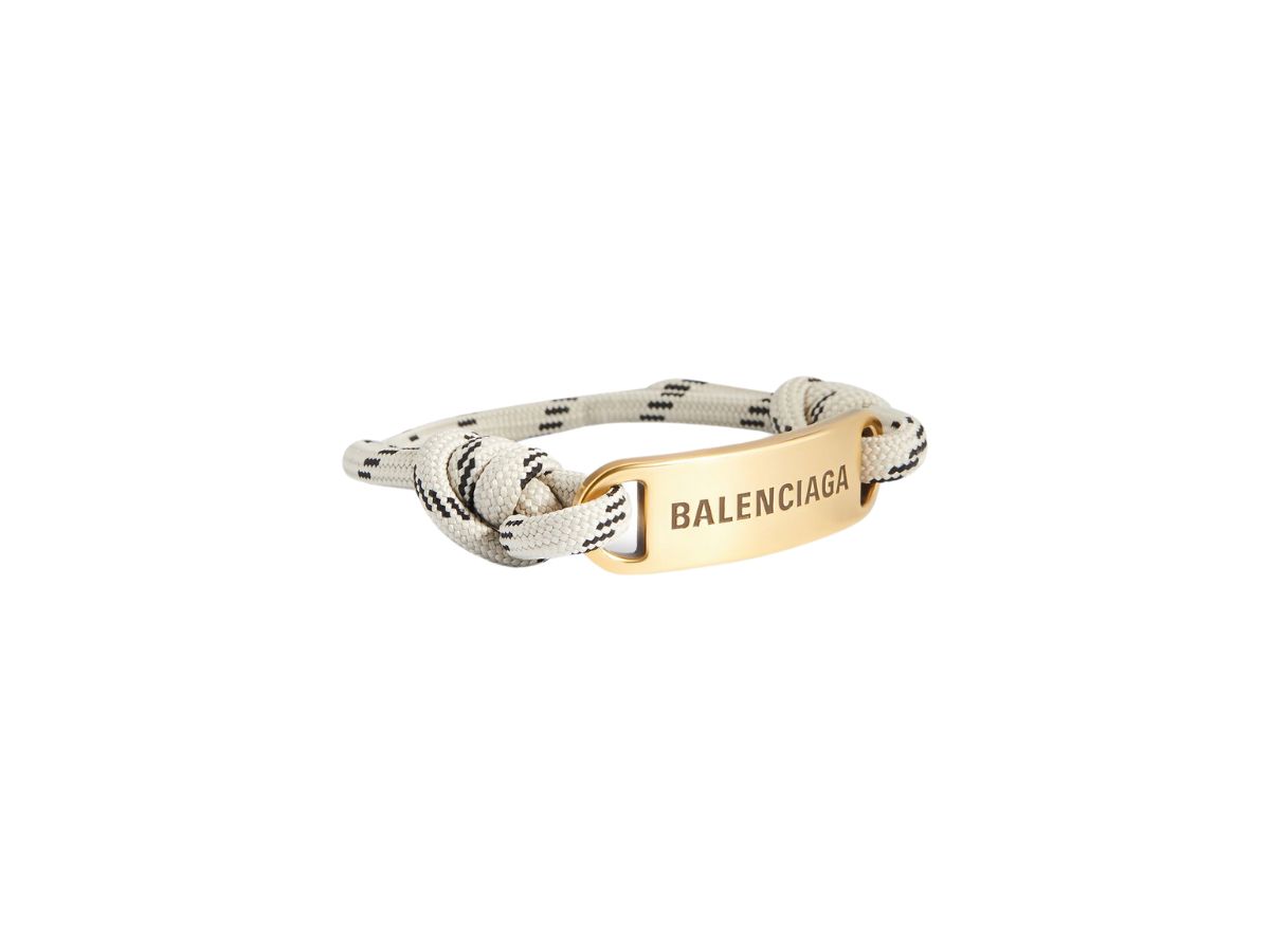https://d2cva83hdk3bwc.cloudfront.net/balenciaga-plate-bracelet-in-beige-and-black-polyester-and-cotton-and-aged-gold-brass-2.jpg