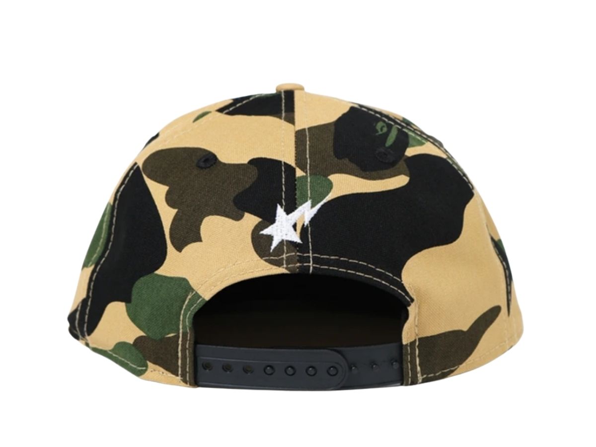 https://d2cva83hdk3bwc.cloudfront.net/bape-1st-camo-new-era-snap-back-cap-yellow-2.jpg