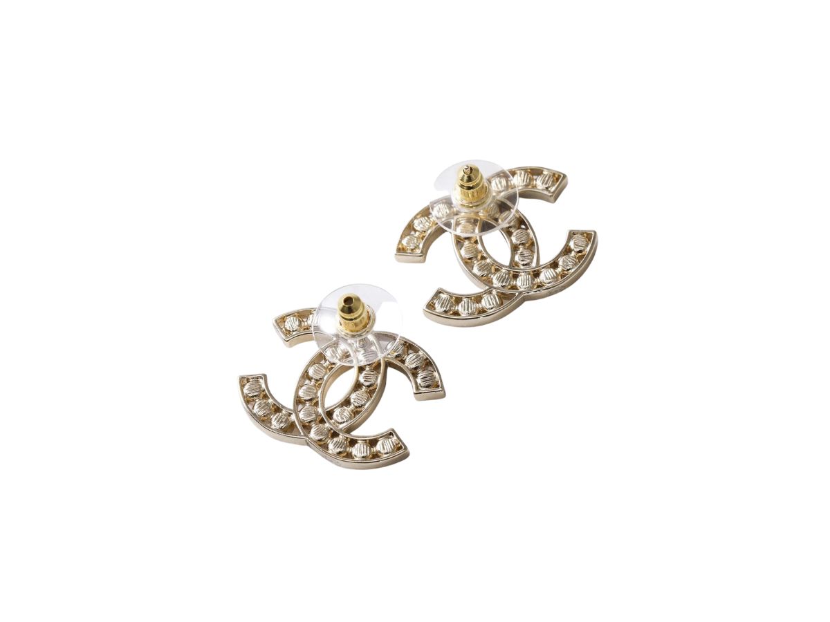 https://d2cva83hdk3bwc.cloudfront.net/chanel-cc-stud-earrings-in-champagne-gold-tone-metal-with-crystals-2.jpg