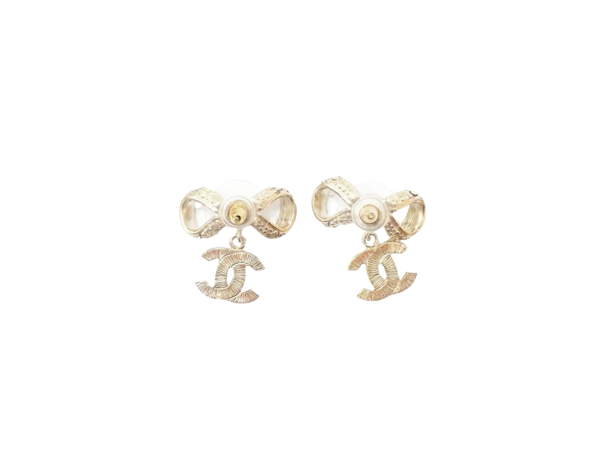 https://d2cva83hdk3bwc.cloudfront.net/chanel-ribbon-bow-cc-piercing-earrings-in-light-gold-metal-with-crystal-2.jpg