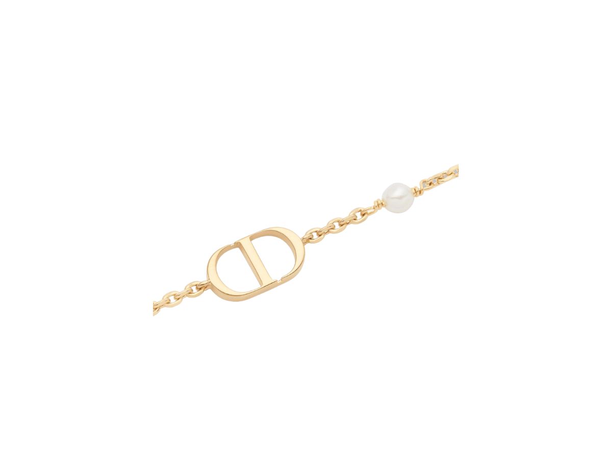 https://d2cva83hdk3bwc.cloudfront.net/dior-petit-cd-bracelet-in-gold-finish-metal-with-a-white-resin-pearl-2.jpg