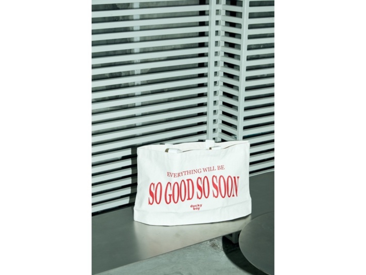 https://d2cva83hdk3bwc.cloudfront.net/duckyboy-so-good-so-soon-tote-ivory-red-2.jpg
