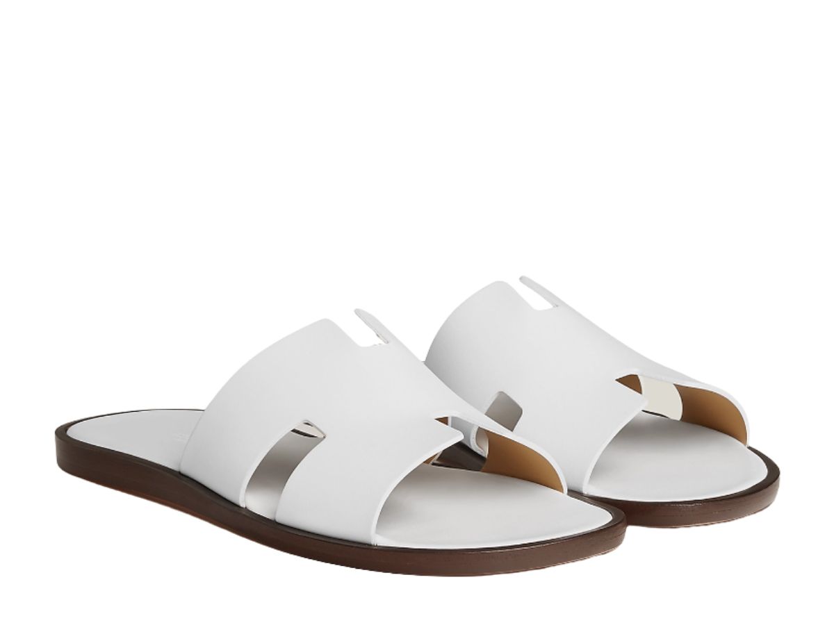 https://d2cva83hdk3bwc.cloudfront.net/hermes-izmir-sandal-in-calfskin-with-iconic-h-cut-out-and-raw-edged-detail-blanc-2.jpg