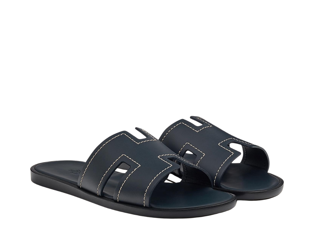 https://d2cva83hdk3bwc.cloudfront.net/hermes-izmir-sandal-in-calfskin-with-stitched-detail-and-iconic-h-cut-out-marine-2.jpg