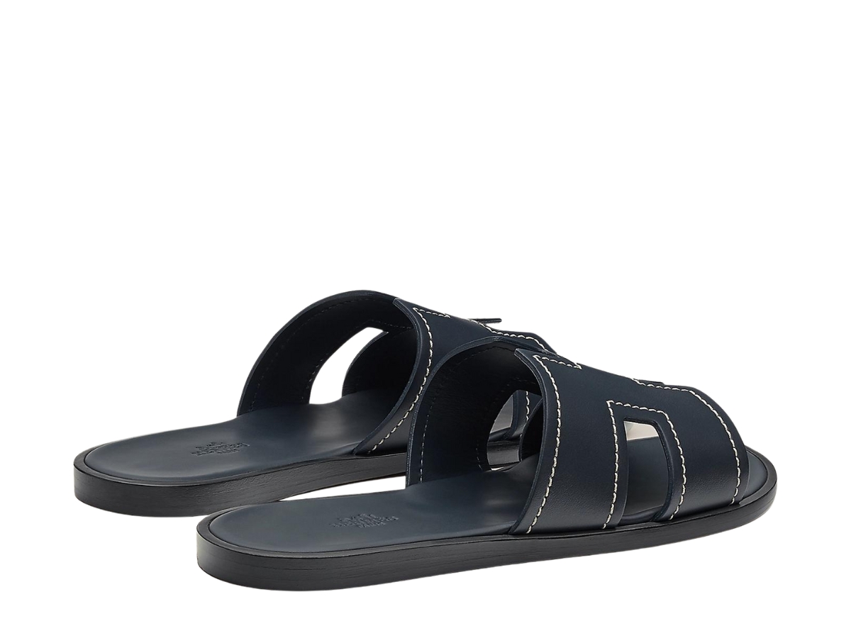 https://d2cva83hdk3bwc.cloudfront.net/hermes-izmir-sandal-in-calfskin-with-stitched-detail-and-iconic-h-cut-out-marine-3.jpg