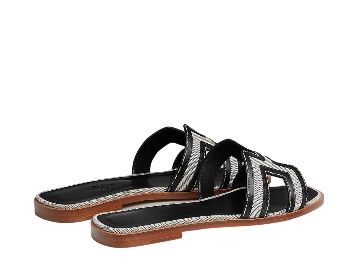 https://d2cva83hdk3bwc.cloudfront.net/hermes-oran-sandal-in-calfskin-and-h-canvas-with-iconic-h-cut-out-prunoir-noir-3.jpg