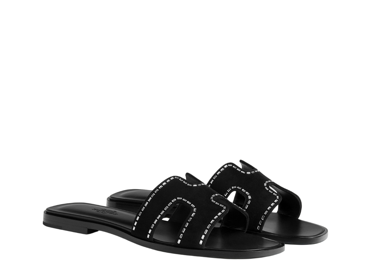 https://d2cva83hdk3bwc.cloudfront.net/hermes-oran-sandal-in-calfskin-with-iconic-h-cut-out-rhinestone-details-noir-2.jpg
