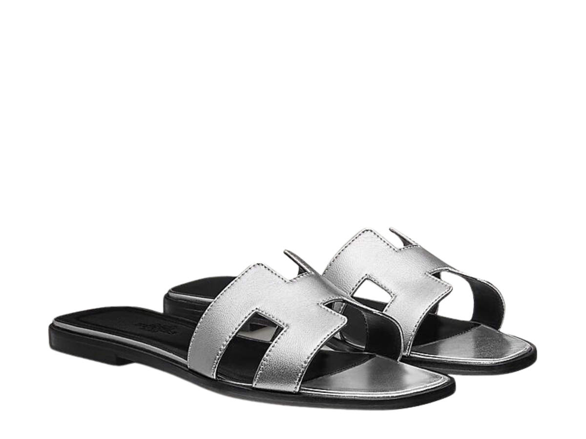 https://d2cva83hdk3bwc.cloudfront.net/hermes-oran-sandal-in-nappa-leather-with-metallic-finish-and-iconic-h-cut-out-gris-argente-vieilli-2.jpg