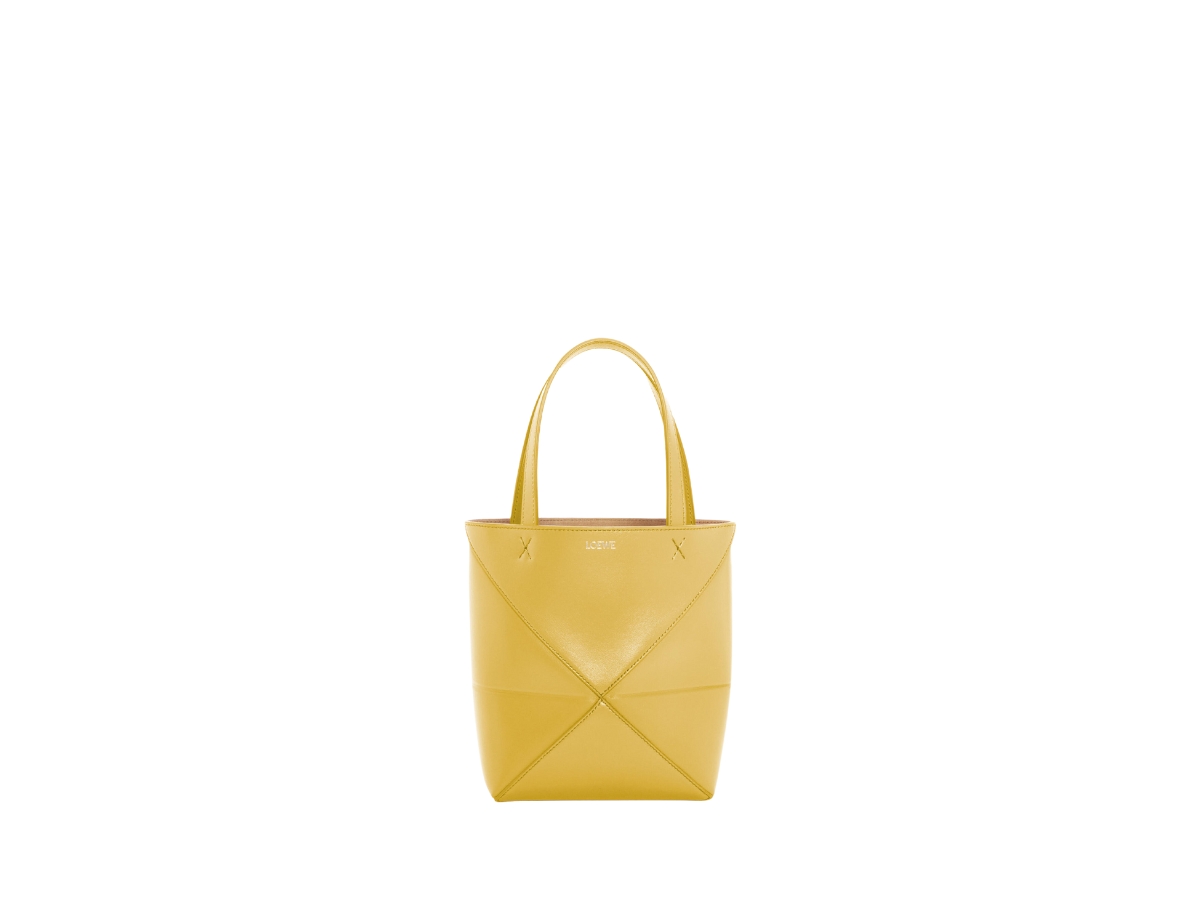 https://d2cva83hdk3bwc.cloudfront.net/loewe-mini-puzzle-fold-tote-in-shiny-calfskin-with-gold-embossed-bright-ochre-1.jpg