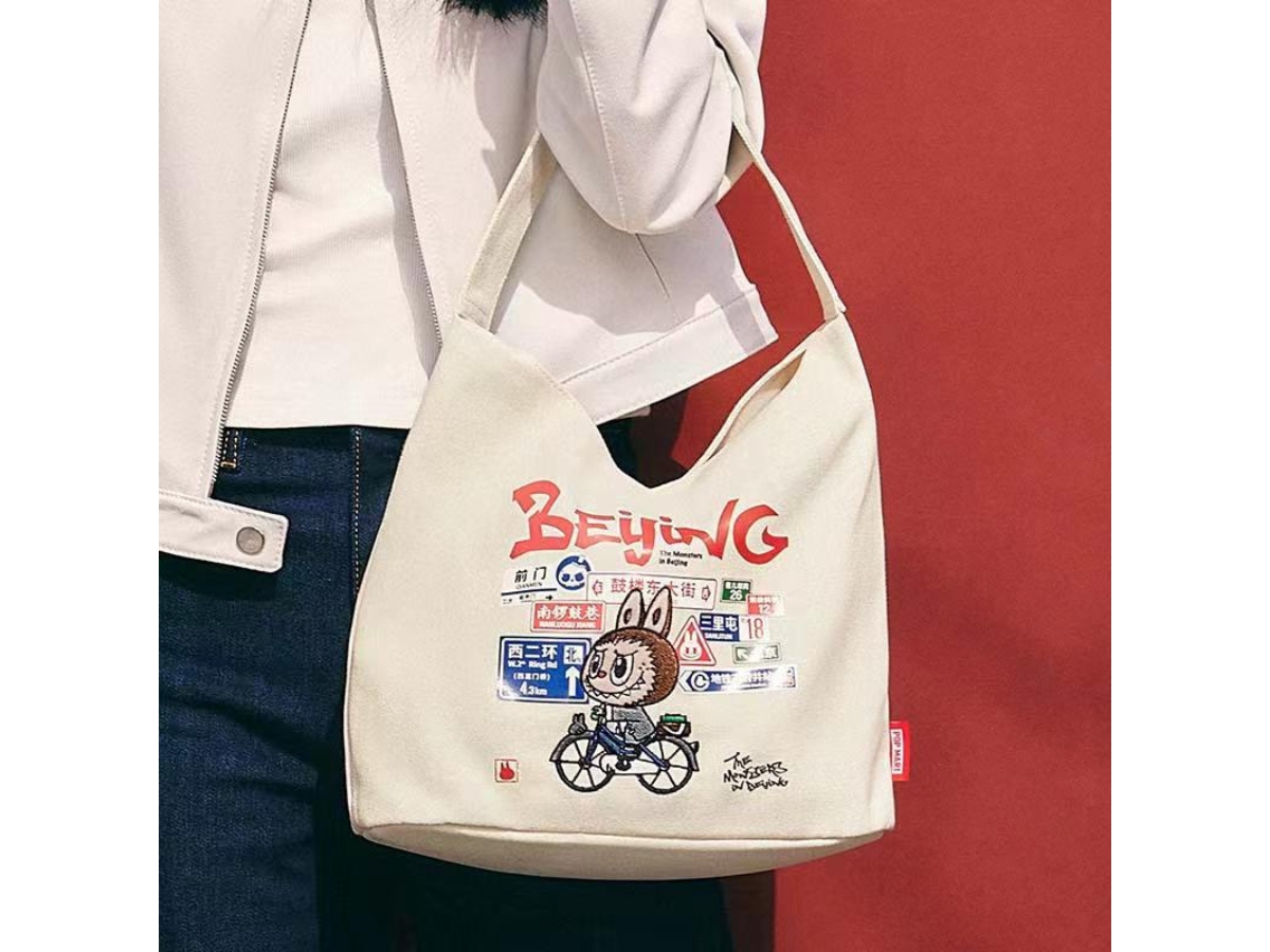 https://d2cva83hdk3bwc.cloudfront.net/pop-mart-labubu-the-monsters-beijing-series-cross-body-handbag-canvas-bag-2.jpg