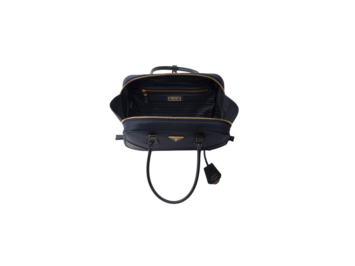 https://d2cva83hdk3bwc.cloudfront.net/prada-re-edition-1978-medium-in-re-nylon-and-saffiano-leather-two-handle-bag-with-metal-hardware-navy-4.jpg