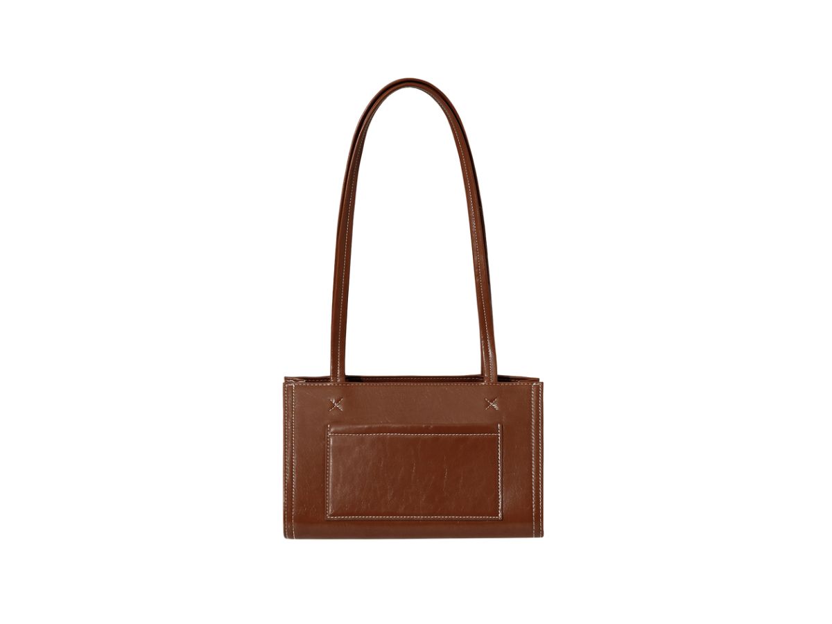 https://d2cva83hdk3bwc.cloudfront.net/stand-oil-oblong-bag-tiny-in-vegan-leather-brown-3.jpg