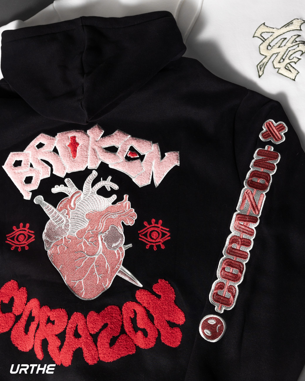 https://d2cva83hdk3bwc.cloudfront.net/urthe_urthe-broken-corazon-hoodie-black-3.jpg